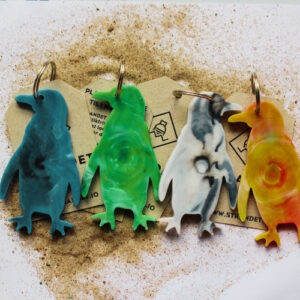 Fire nøgleringe i flotte farver på baggrund af sand